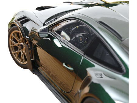 Green sports car with gold wheel.