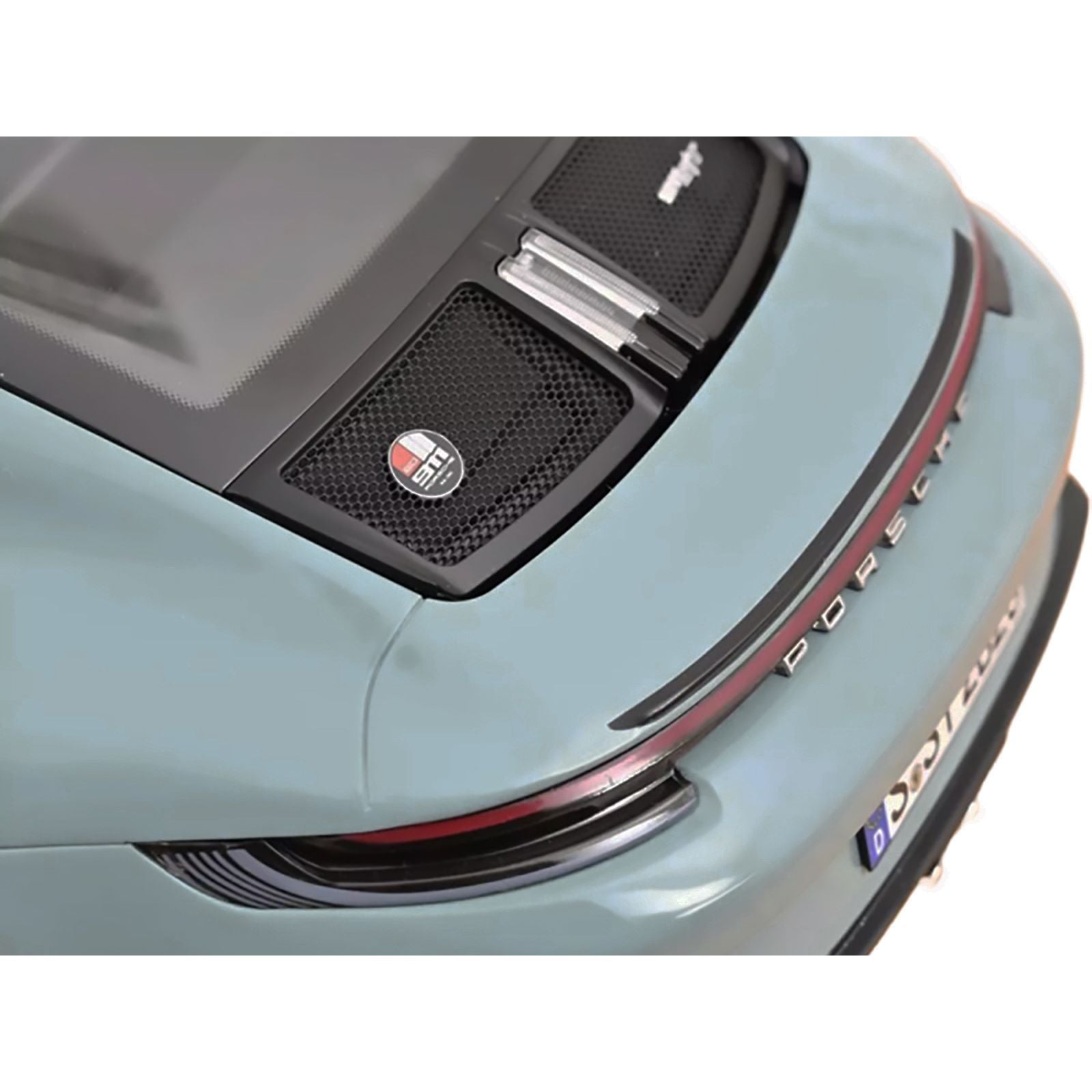 Rear view of a light blue Porsche car.