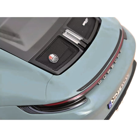 Rear view of a light blue Porsche car.