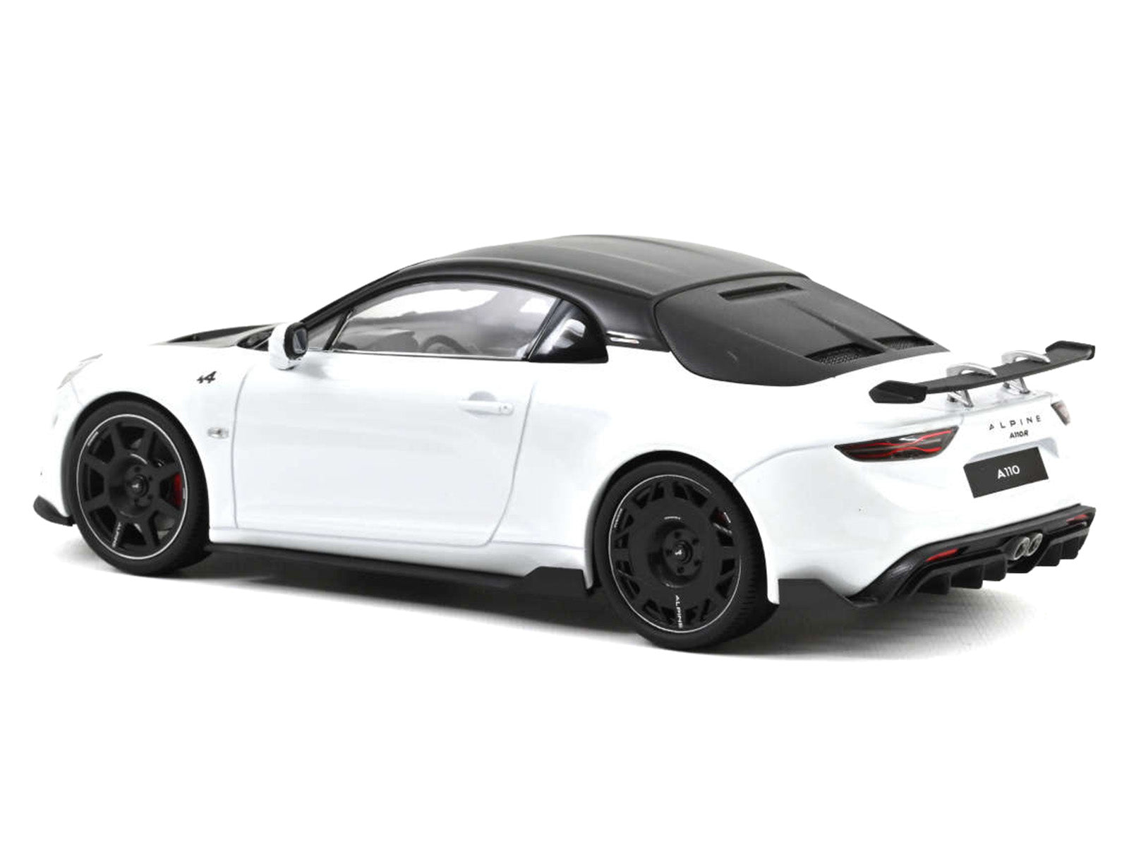 White sports car with black roof.