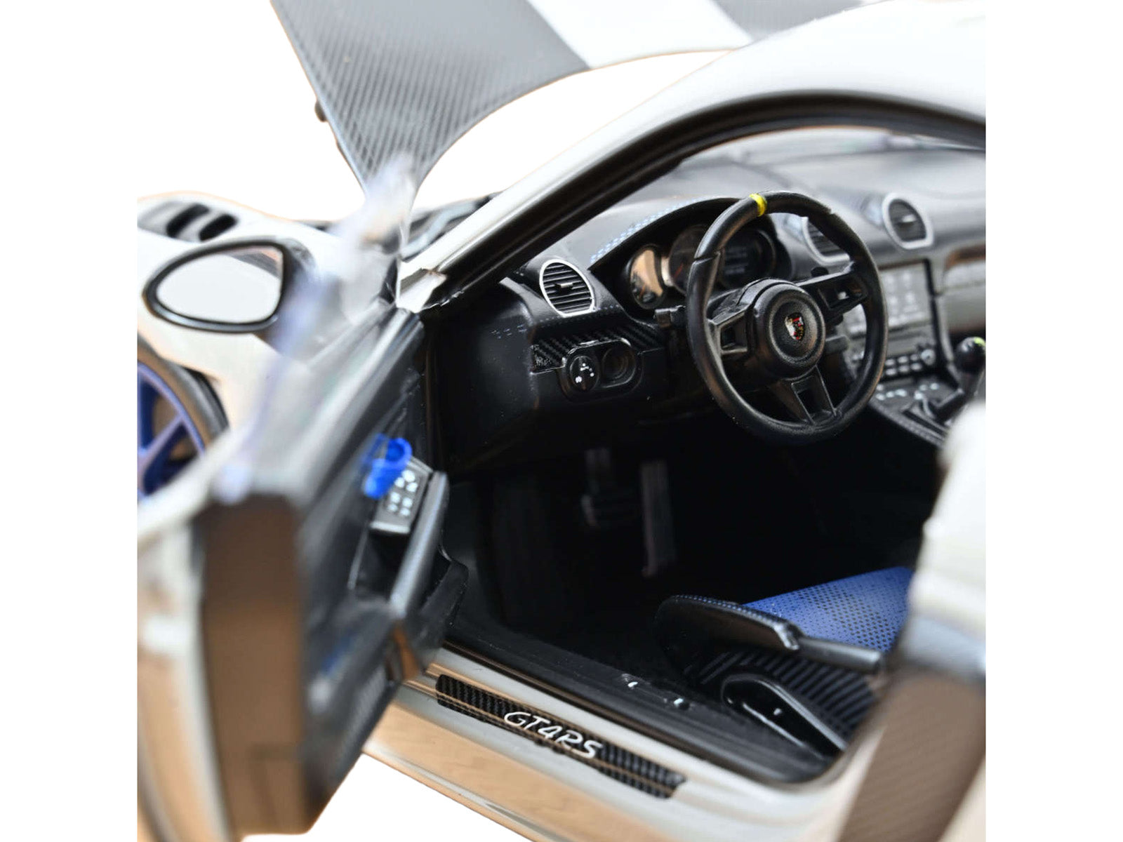 Interior of a white sports car with door open.