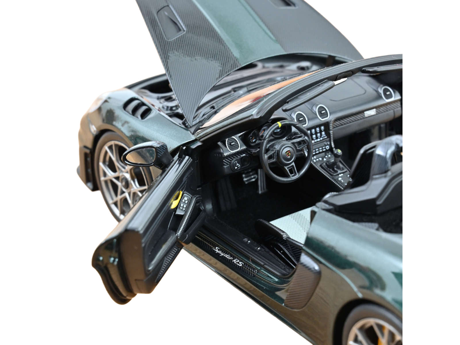 Green convertible car model with open hood and door.