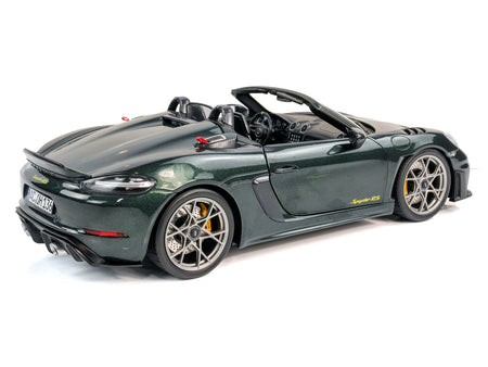 Green convertible sports car on white background.
