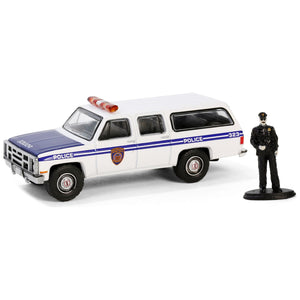 1985 GMC Suburban 2500 "New York City Transit Police Department" White with Blue Stripes and Police Officer Figure "The Hobby Shop" Series 16 1/64 Diecast Model Car by Greenlight