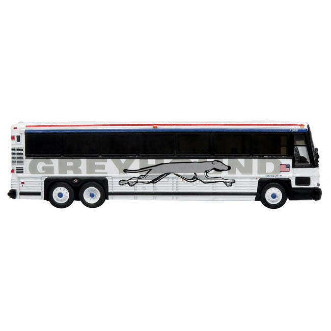 2001 MCI D4000 Coach Bus "Greyhound" White with Red and Blue Stripes "Vintage Bus & Motorcoach Collection" Limited Edition to 504 pieces Worldwide 1/87 (HO) Diecast Model by Iconic Replicas - Iconic Replicas - ModelCars.com