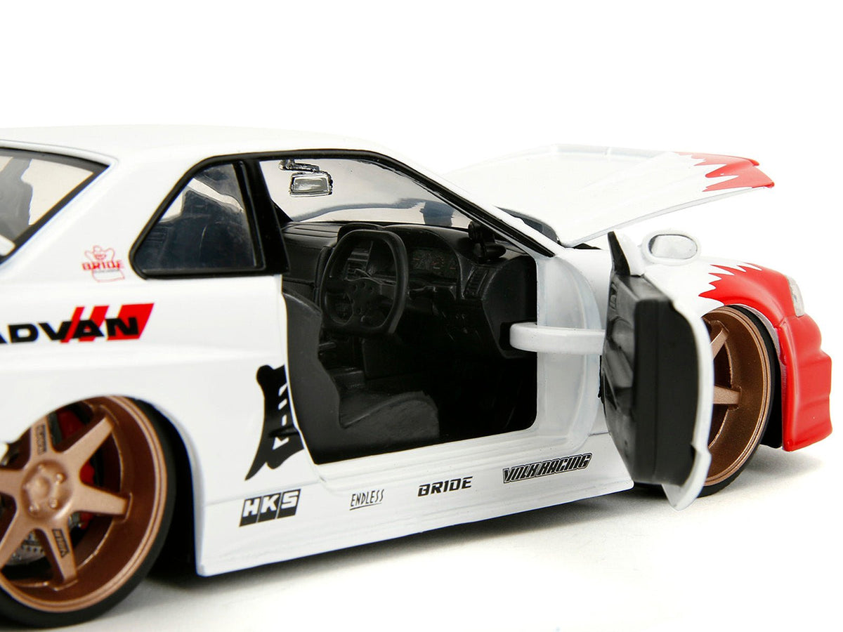 2002 Nissan Skyline GT-R (R34) RHD (Right Hand Drive) White with Red Graphics and Ryu Diecast Figure "Street Fighter" Video Game "Anime Hollywood Rides" Series 1/24 Diecast Model Car by Jada-Jada-ModelCars.com