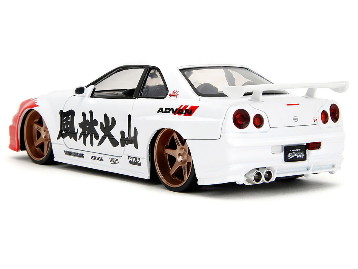 2002 Nissan Skyline GT-R (R34) RHD (Right Hand Drive) White with Red Graphics and Ryu Diecast Figure "Street Fighter" Video Game "Anime Hollywood Rides" Series 1/24 Diecast Model Car by Jada-Jada-ModelCars.com