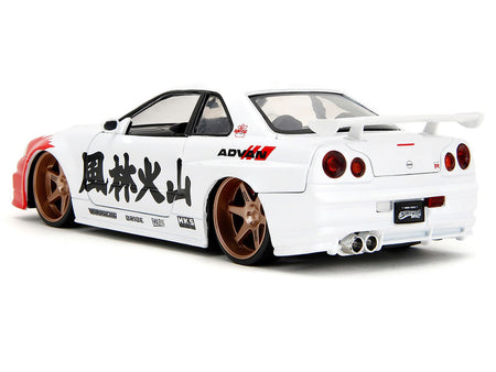2002 Nissan Skyline GT-R (R34) RHD (Right Hand Drive) White with Red Graphics and Ryu Diecast Figure "Street Fighter" Video Game "Anime Hollywood Rides" Series 1/24 Diecast Model Car by Jada-Jada-ModelCars.com