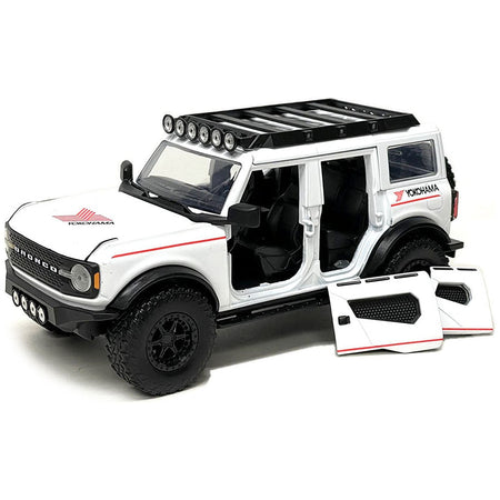 2021 Ford Bronco White with Red Stripes and Roof Rack "Yokohama Tires" "Just Trucks" Series 1/24 Diecast Model Car by Jada - Jada - ModelCars.com