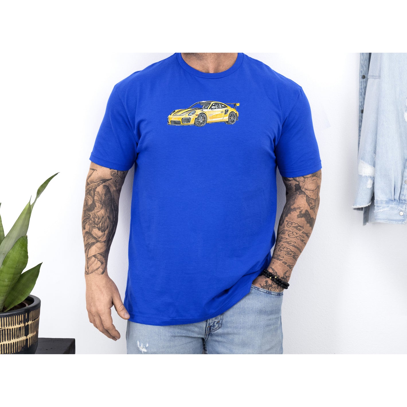 Man wearing blue t-shirt with car graphic.