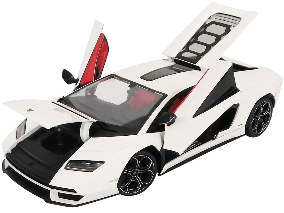 White sports car with open doors and hood.