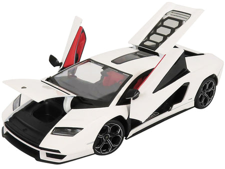White sports car with open doors and hood.