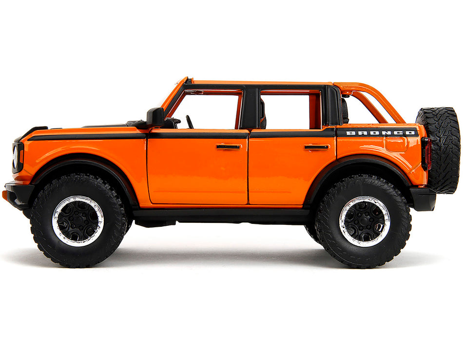 2021 Ford Bronco Open-Top Orange with Black Stripes and Hood with Extra Wheels "Just Trucks" Series 1/24 Diecast Model Car by Jada