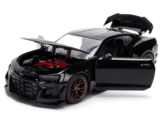 Black sports car model with open hood and doors.