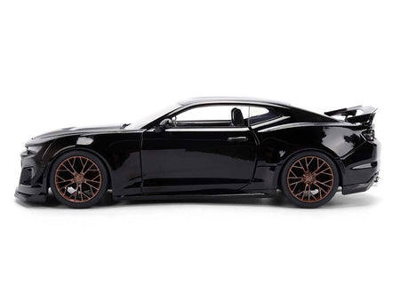 Black sports car with bronze wheels.