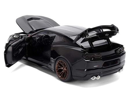 Black sports car model with open doors and hood.