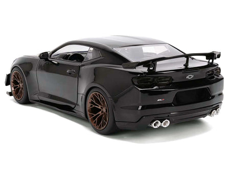 Black sports car with bronze wheels.