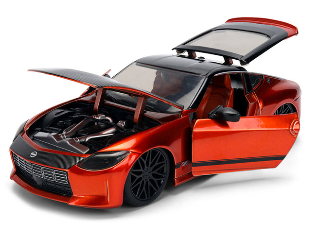Orange model car with open doors and hood.