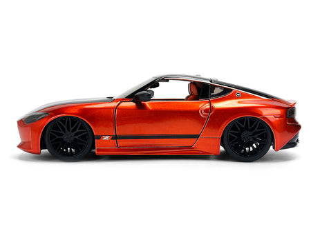 Orange sports car with black wheels.