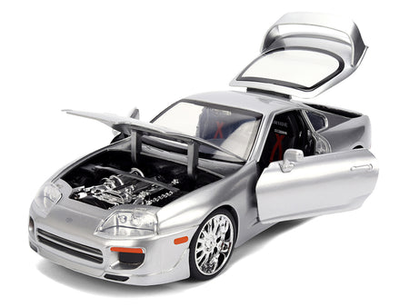 Silver toy car with open doors and hood.