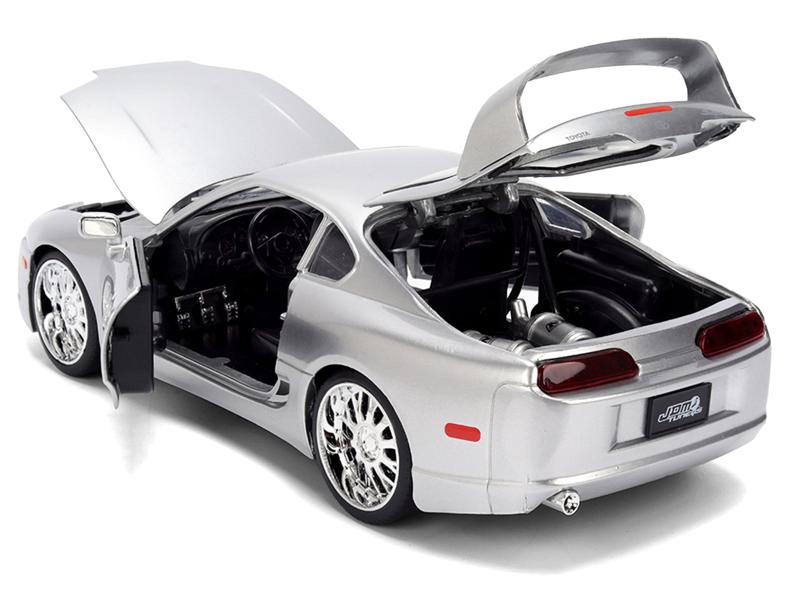 Silver sports car with open doors and hood.