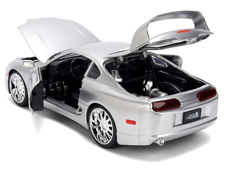 Silver sports car with open doors and hood.