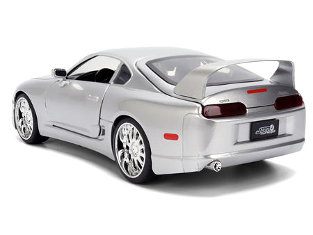 Silver sports car model on white background.