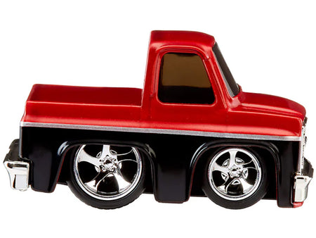 Red and black toy truck with chrome wheels.