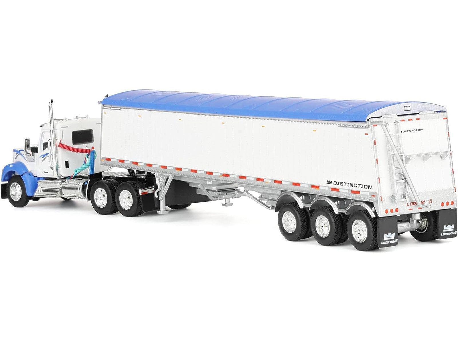 Toy semi-truck with white trailer and blue tarp.