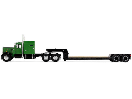 Green semi-truck with a flatbed trailer.