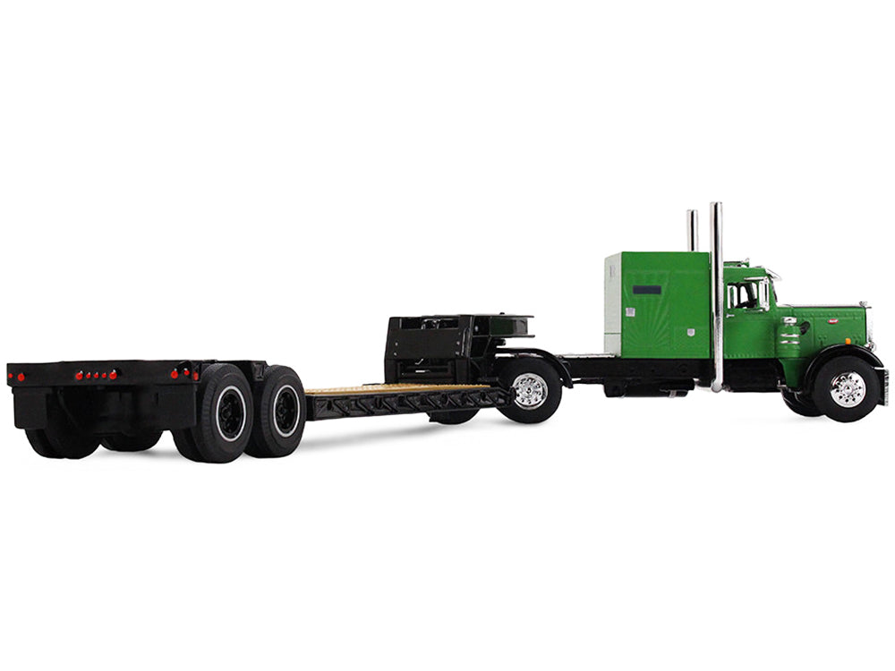 Green semi-truck pulling a flatbed trailer.