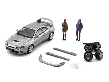 Silver Toyota Celica model with figures and parts