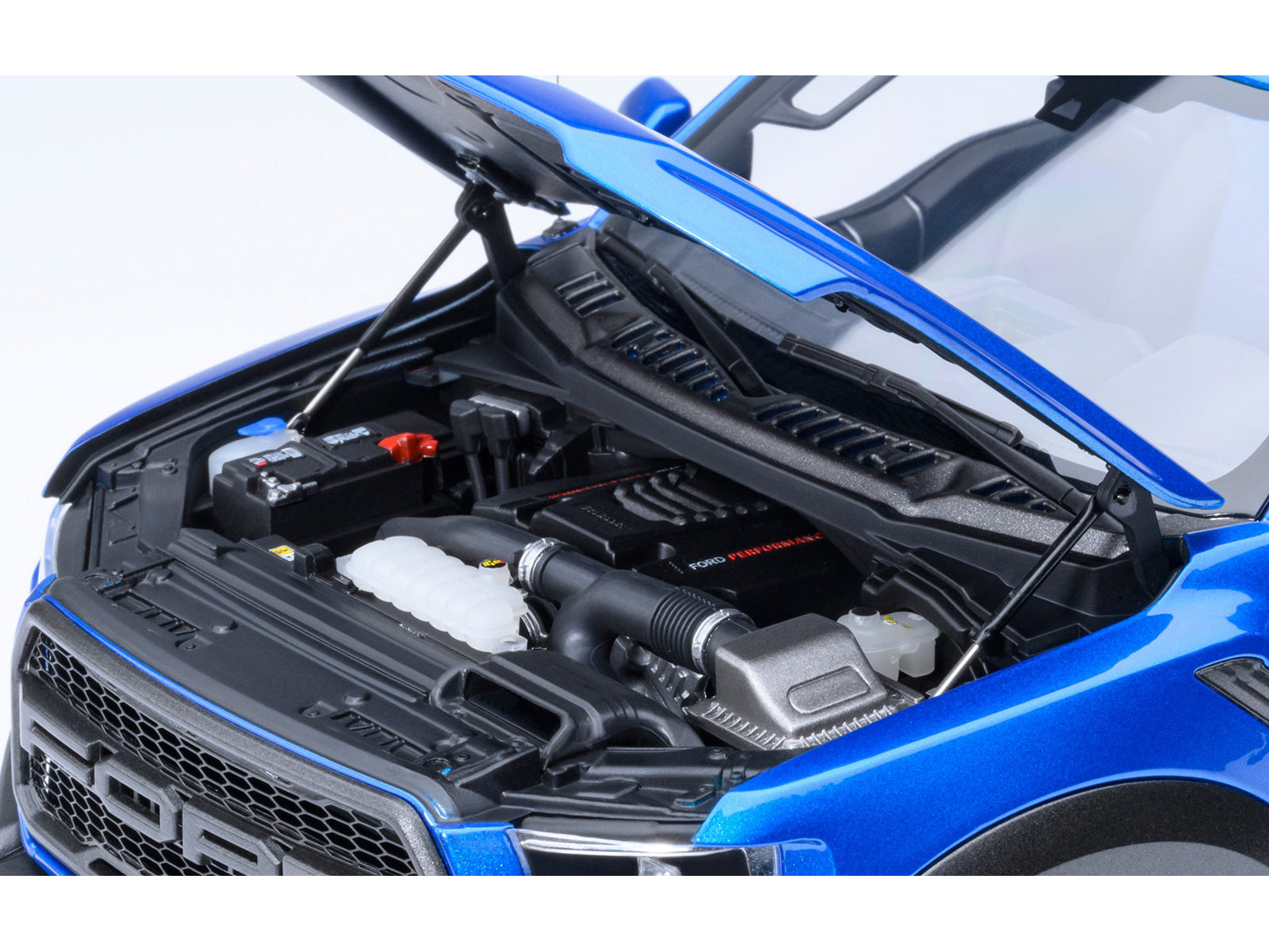Blue car engine with hood open.