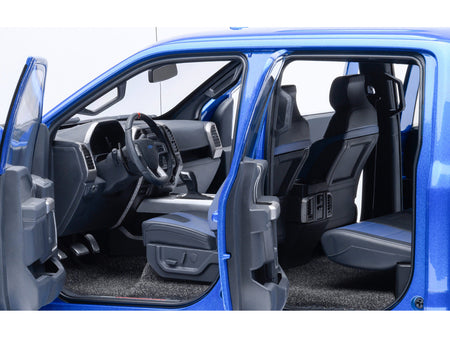 Blue truck interior with open doors.