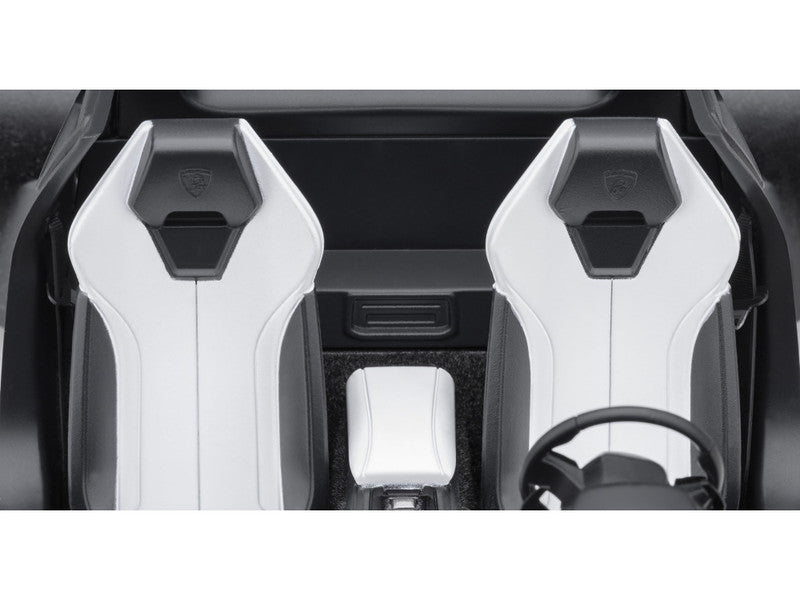 Car interior with white seats and steering wheel.