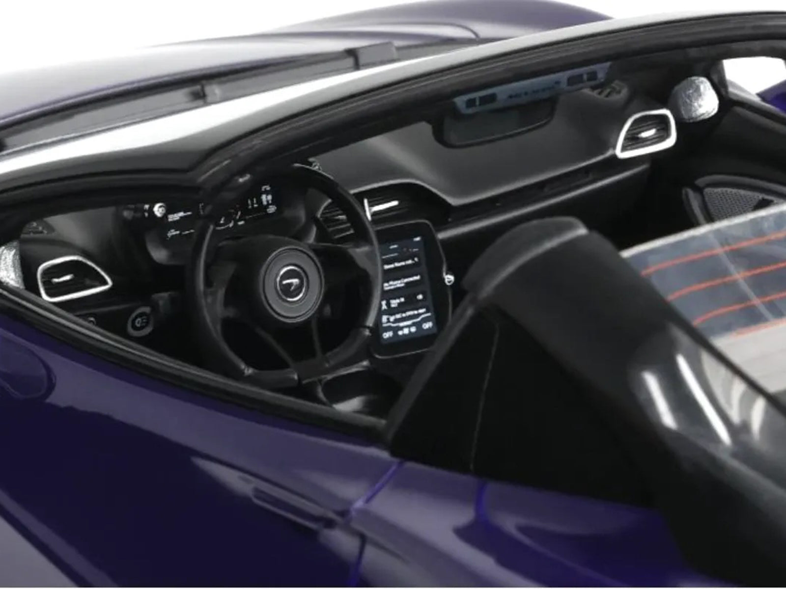 Interior view of a purple sports car's dashboard and steering wheel