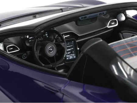 Interior view of a purple sports car's dashboard and steering wheel
