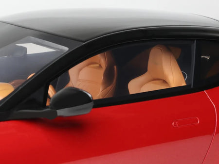 Red sports car interior with tan leather seats.