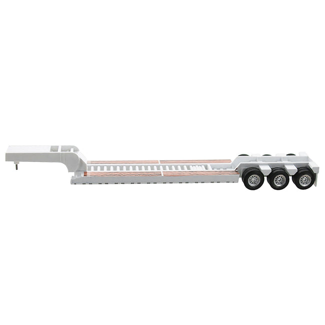 White lowboy trailer with triple axle