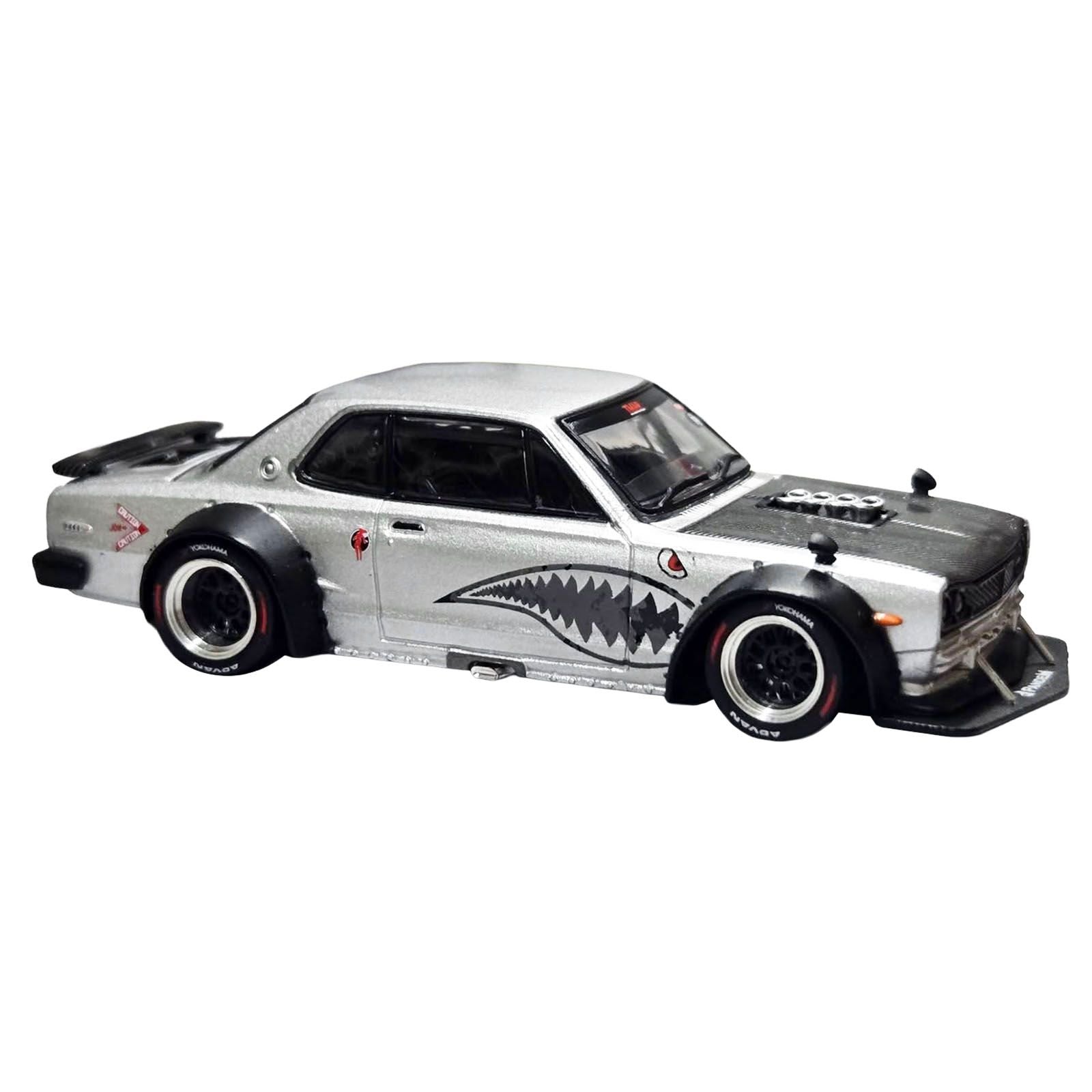 Silver custom car with shark mouth graphic