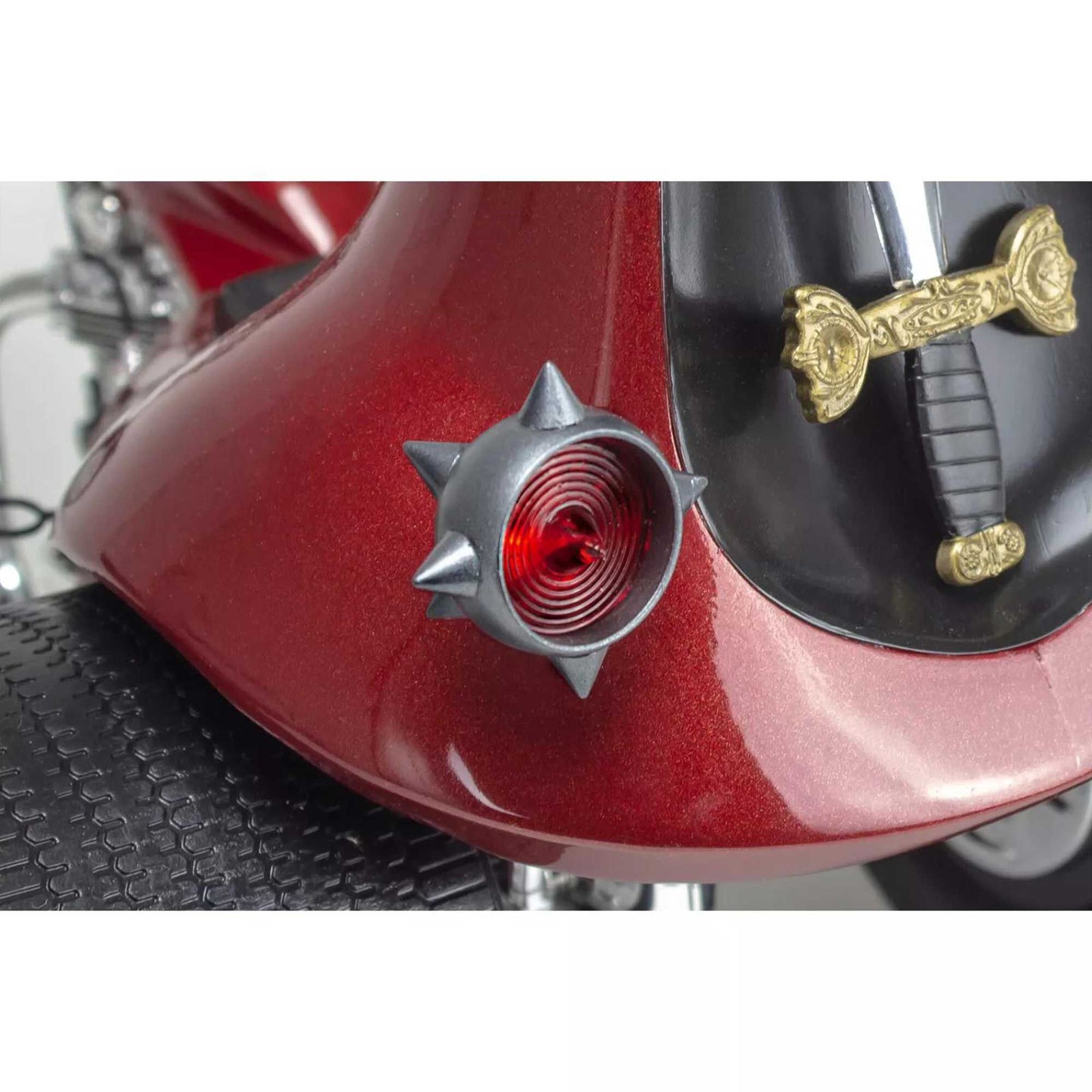 Red motorcycle fender with spiked light and sword detail