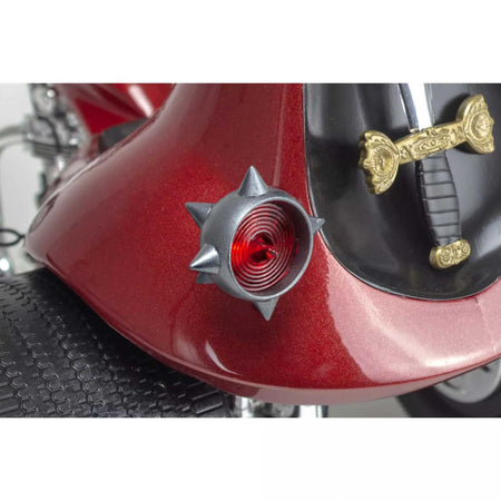 Red motorcycle fender with spiked light and sword detail