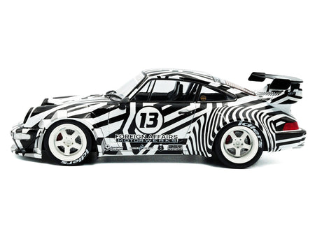 Zebra-striped race car, number 13.