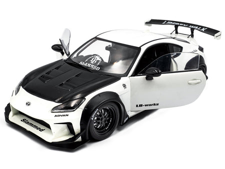 White & black custom sports car model with open doors.