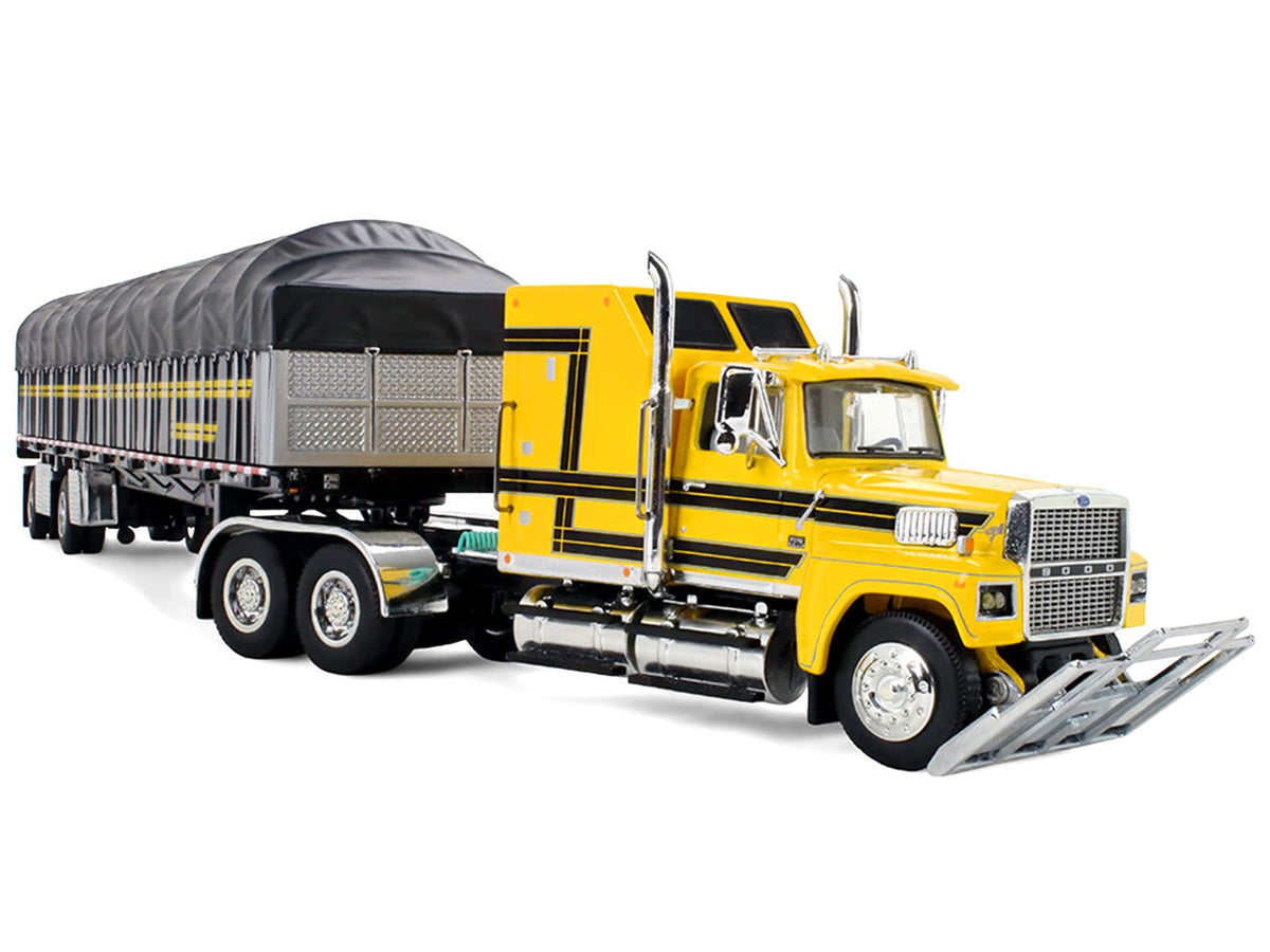 Ford LTL 9000 with 60" Aerodyne Sleeper and 53' Wilson Roadbrute Flatbed Trailer with Covered Wagon Yellow with Black Stripes 1/64 Diecast Model by DCP/First Gear-First Gear-ModelCars.com