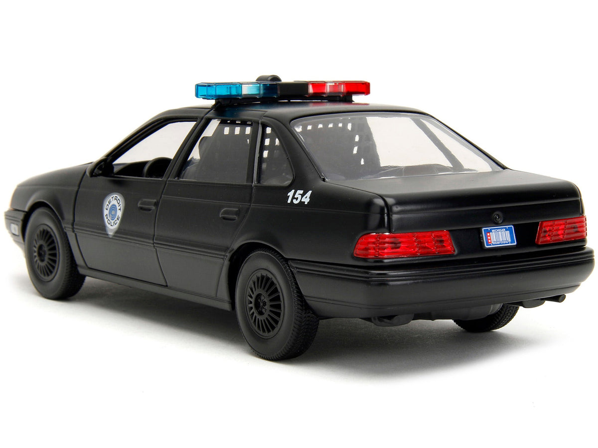 Ford Taurus OCP Matt Black "Detroit Police" and Robocop Diecast Figure 35th Anniversary "Robocop" (1987) Movie "Hollywood Rides" Series 1/24 Diecast Model Car by Jada-Jada-ModelCars.com