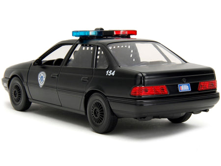 Ford Taurus OCP Matt Black "Detroit Police" and Robocop Diecast Figure 35th Anniversary "Robocop" (1987) Movie "Hollywood Rides" Series 1/24 Diecast Model Car by Jada-Jada-ModelCars.com