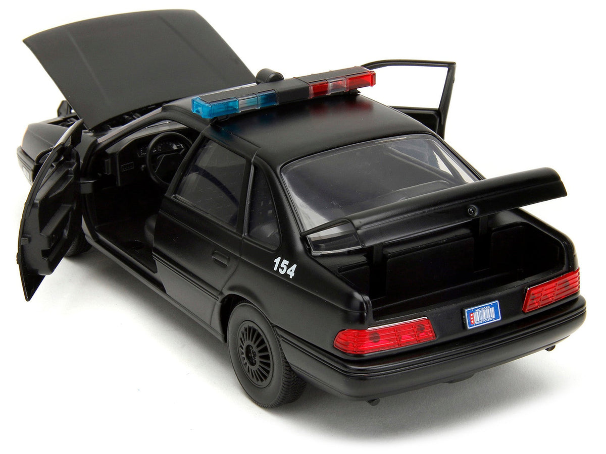 Ford Taurus OCP Matt Black "Detroit Police" and Robocop Diecast Figure 35th Anniversary "Robocop" (1987) Movie "Hollywood Rides" Series 1/24 Diecast Model Car by Jada-Jada-ModelCars.com