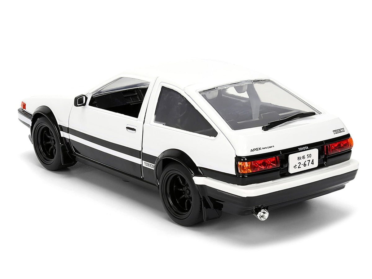 Toyota Trueno (AE86) RHD (Right Hand Drive) White and Black with Graphics and Takumi Diecast Figure "Initial D" (1998-2021) TV Series "Anime Hollywood Rides" Series 1/24 Diecast Model by Jada-Jada-ModelCars.com