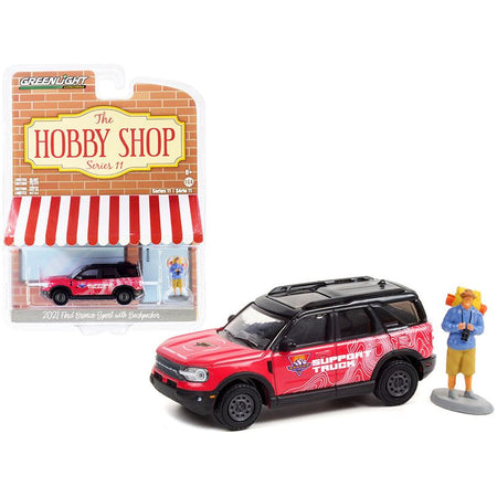 2021 Ford Bronco Sport Pink and Black "Off - Roadeo Adventure Support Truck" with Backpacker Figurine "The Hobby Shop" Series 11 1/64 Diecast Model Car by Greenlight - Greenlight - ModelCars.com